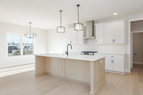 a kitchen with a sink stove and cabinets