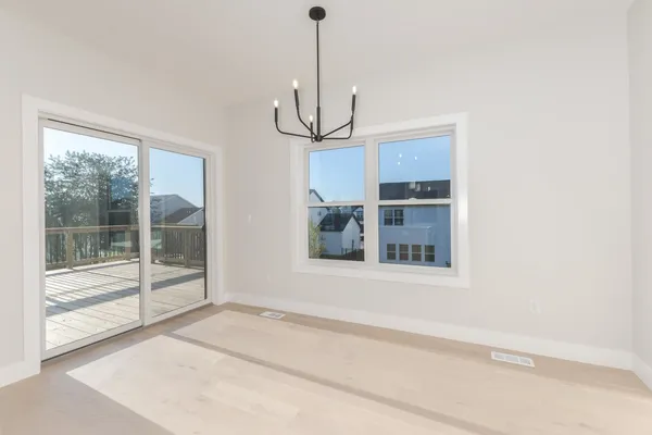 a view of a room with a ceiling fan and window