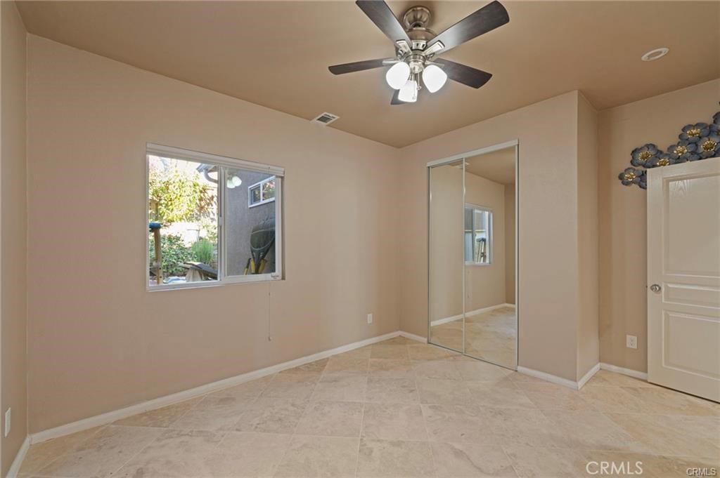 8634 Hunt Canyon Road Corona, CA 92883 - Photo 13 of 31 an empty room with windows and fan
