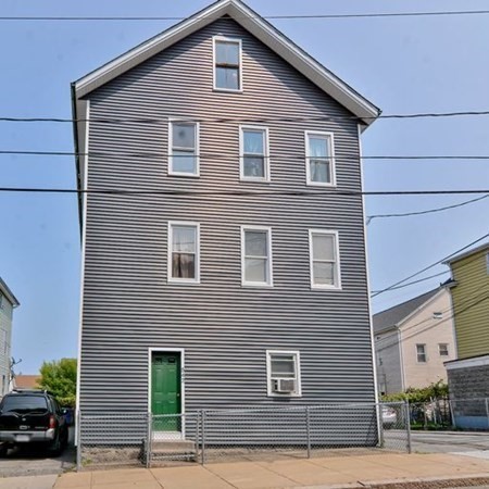 542 4th Street Fall River, MA 02721 - Photo 3 of 5 a front view of a house with a yard