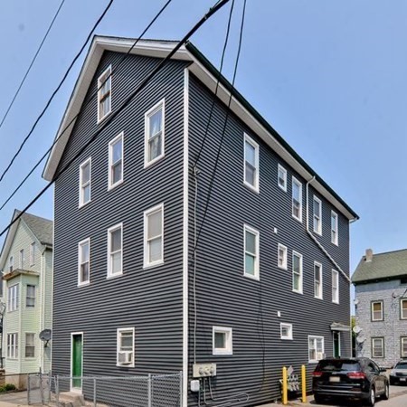 542 4th Street Fall River, MA 02721 - Photo 4 of 5 a front view of a building with parking space