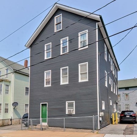 542 4th Street Fall River, MA 02721 - Photo 5 of 5 a brick building that has a street sign on it