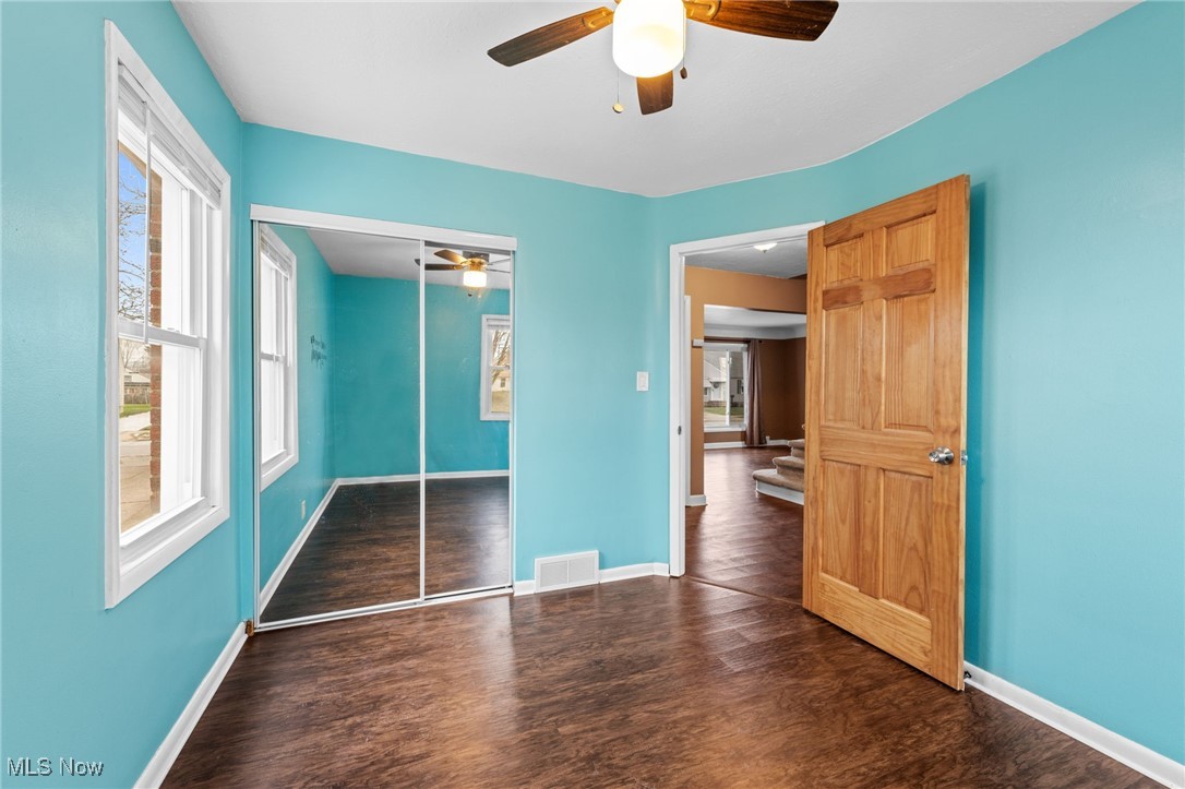 625 Pendley Road Willowick, OH 44095 - Photo 16 of 28 Unfurnished bedroom with dark wood-style flooring, a closet, and ceiling fan