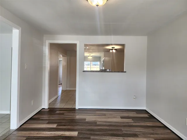 a view of a room with wooden floor and staircase
