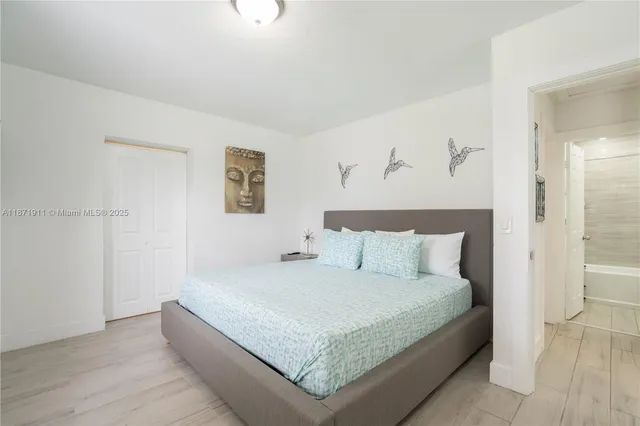 a bedroom with a bed and a night stand