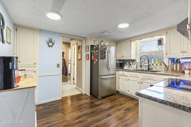 a kitchen with a refrigerator and a sink