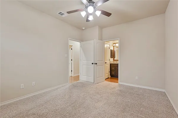 a bathroom with a granite countertop sink toilet and mirror