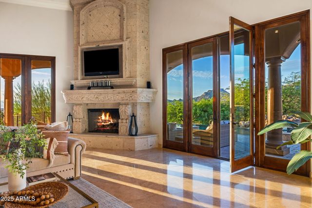 a living room with furniture fireplace and flat screen tv