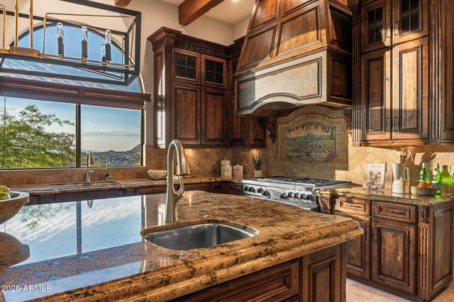 a kitchen with a stove and a wooden floor