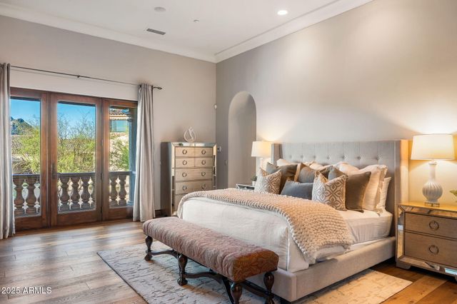 a living room with furniture a floor to ceiling window and potted plant