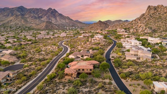 a bedroom with a bed and dresser with mirror