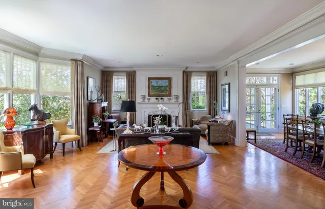 a living room with fireplace furniture and a large window