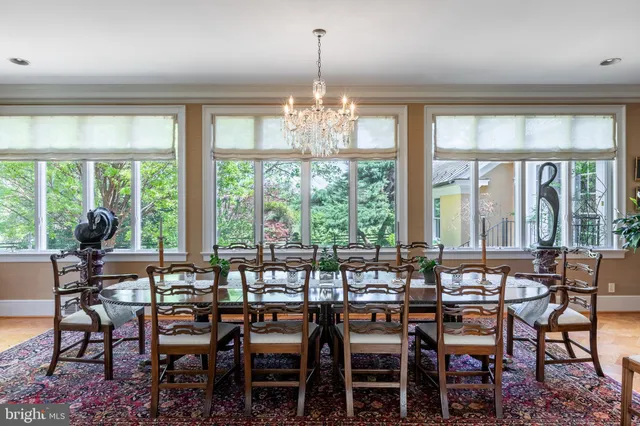 a view of a dining room with furniture large windows and wooden floor