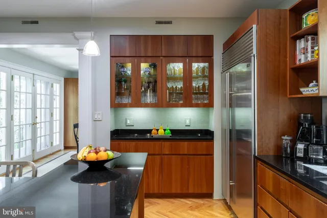 a kitchen with stainless steel appliances granite countertop a refrigerator and a stove