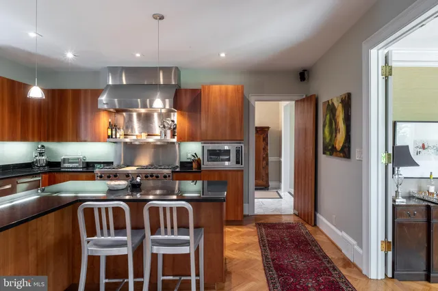 a kitchen with stainless steel appliances granite countertop a stove a refrigerator and a sink