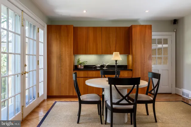 a dining room with furniture and a window