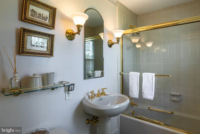 a bathroom with a sink mirror and toilet