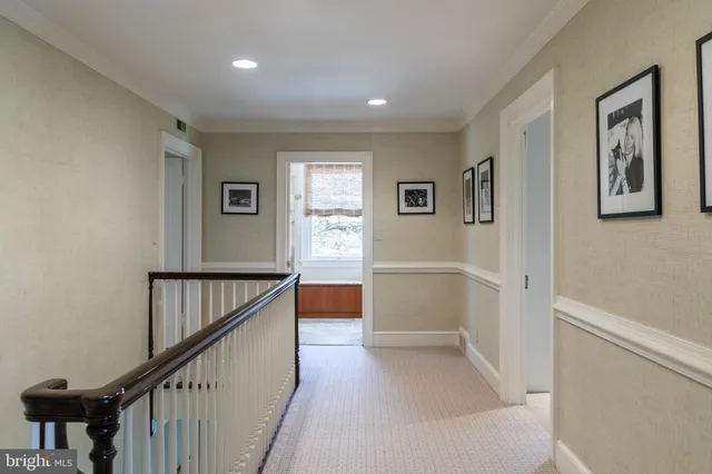 a view of hallway with stairs and wooden floor