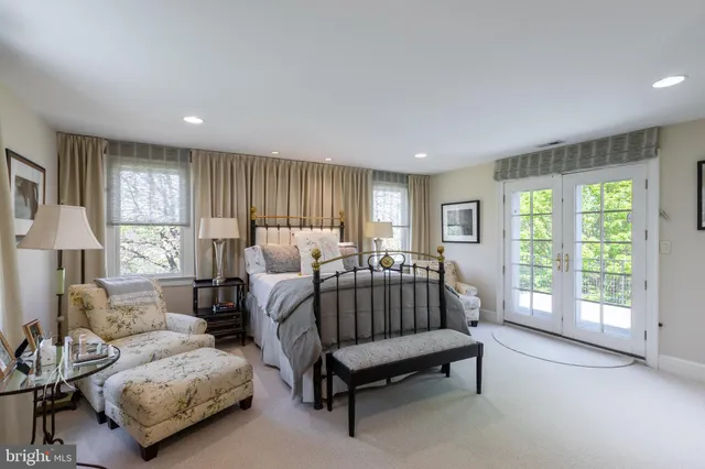 a spacious bedroom with a bed and a couch