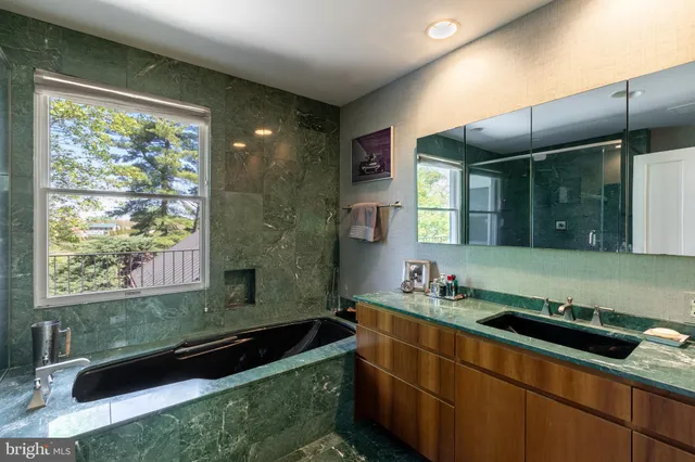 a bathroom with a sink a bathtub and a mirror