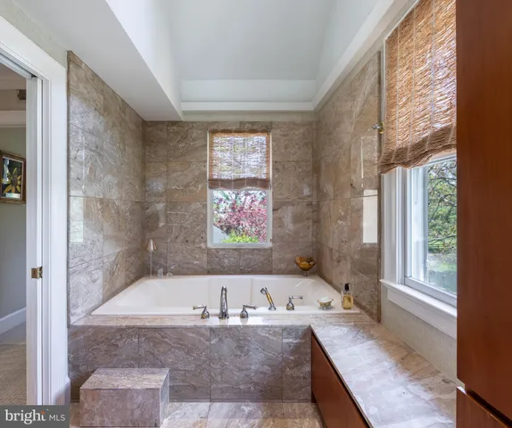 a bath tub sitting in a bathroom next to a window