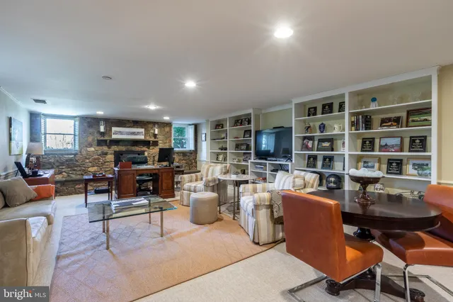 a living room with lots of furniture and a book shelf