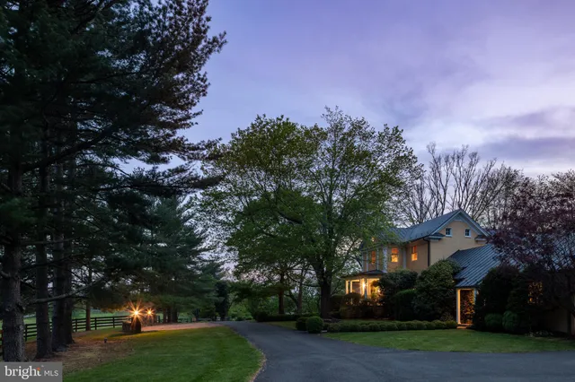 a view of a house with a yard and tree s