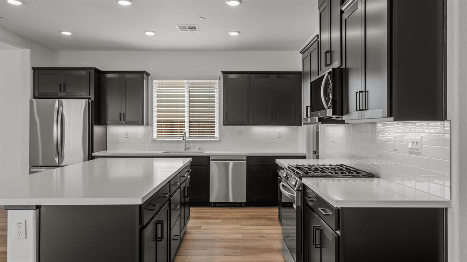 229 Rafters Court Lincoln, CA 95648 - Photo 3 of 13 a kitchen with stainless steel appliances granite countertop a sink a stove and a refrigerator