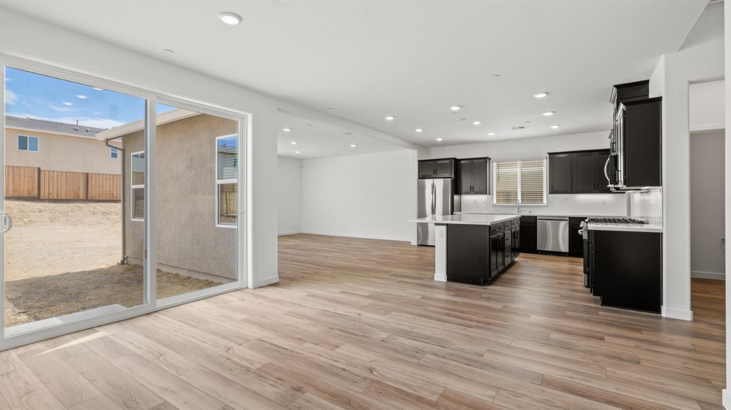 229 Rafters Court Lincoln, CA 95648 - Photo 5 of 13 a kitchen with stainless steel appliances kitchen island granite countertop a stove and a refrigerator