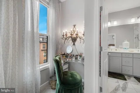 a bathroom with a double vanity sink a toilet and a mirror