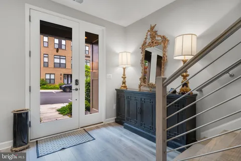 a kitchen with stainless steel appliances granite countertop a refrigerator a stove a sink and a oven