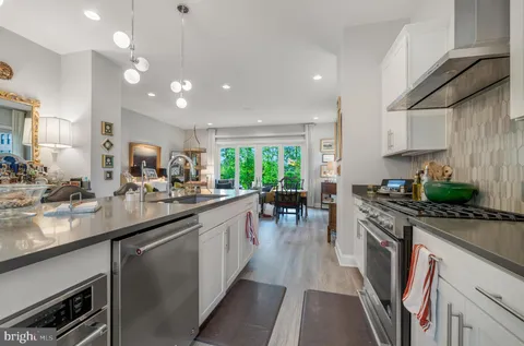 a kitchen with lots of counter top space and wooden floor