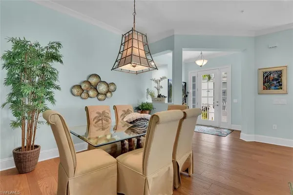 a view of a dining room with furniture wooden floor and chandelier