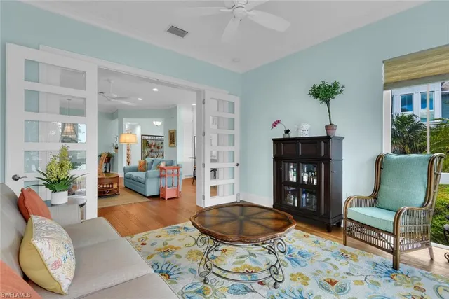 a living room with furniture and a potted plant