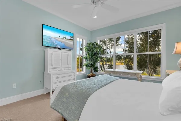 a bedroom with a bed and a large window