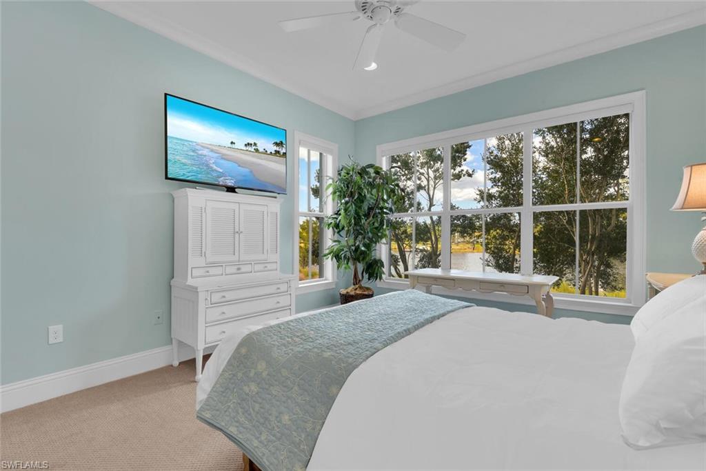 6561 Dominica Drive, Unit 8101 Naples, FL 34113 - Photo 20 of 46 a bedroom with a bed and a large window