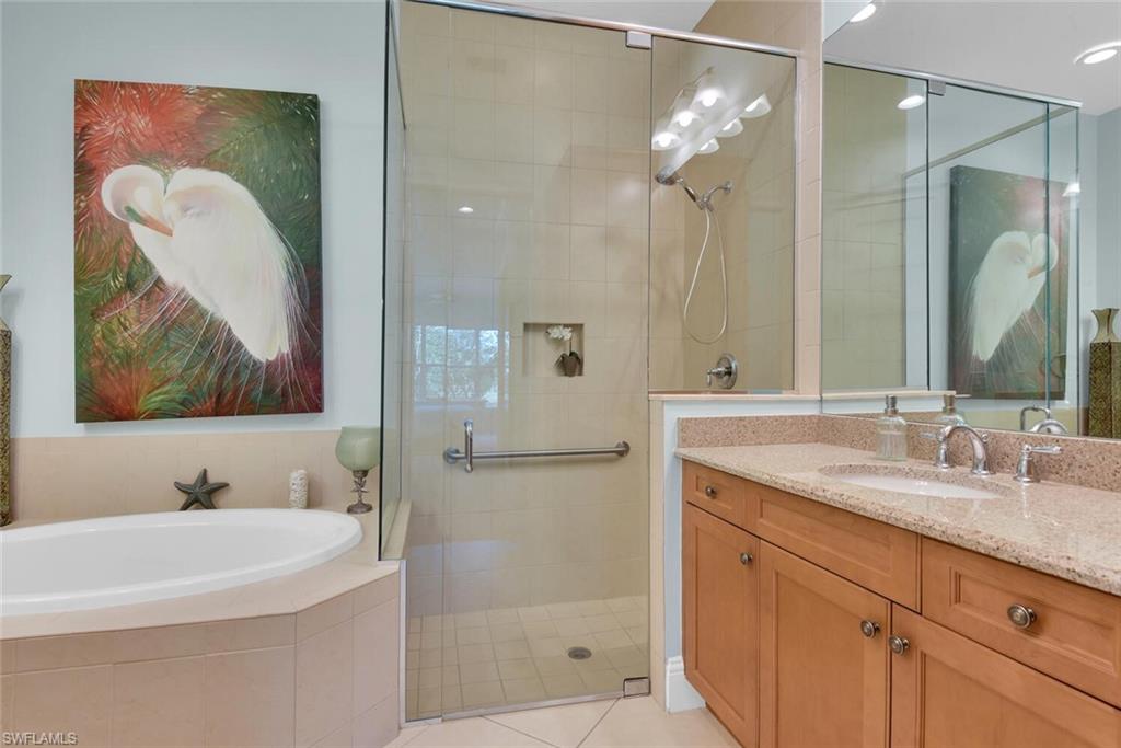 6561 Dominica Drive, Unit 8101 Naples, FL 34113 - Photo 21 of 46 a bathroom with a sink a mirror a vanity and shower