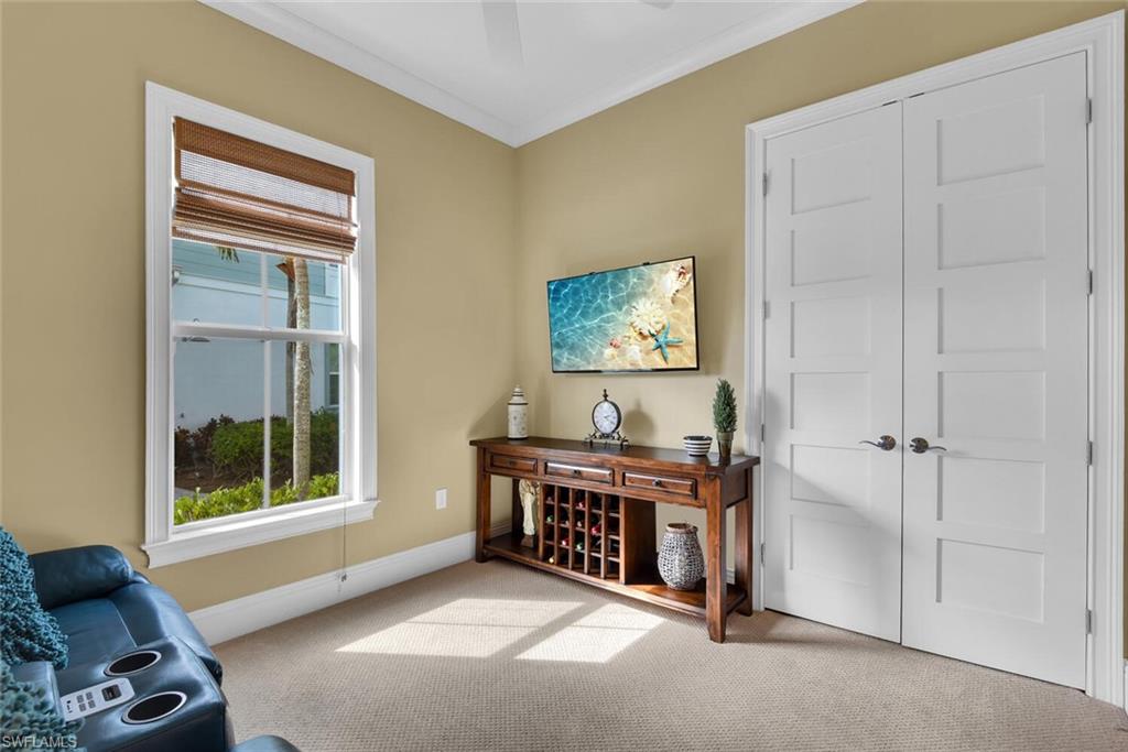 6561 Dominica Drive, Unit 8101 Naples, FL 34113 - Photo 26 of 46 a living room with furniture and a flat screen tv