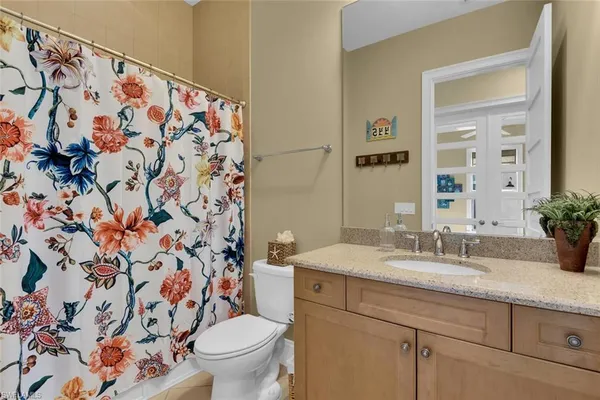 a bathroom with a sink and mirror with toilet