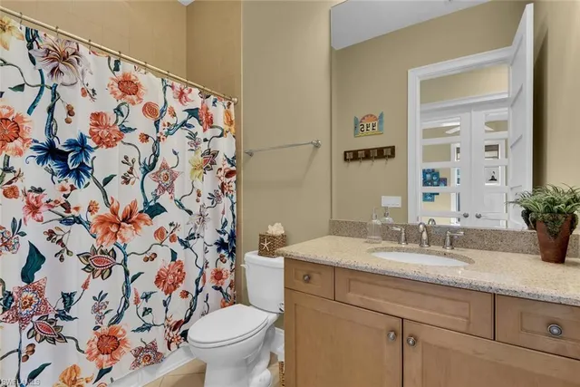 a bathroom with a sink and mirror with toilet