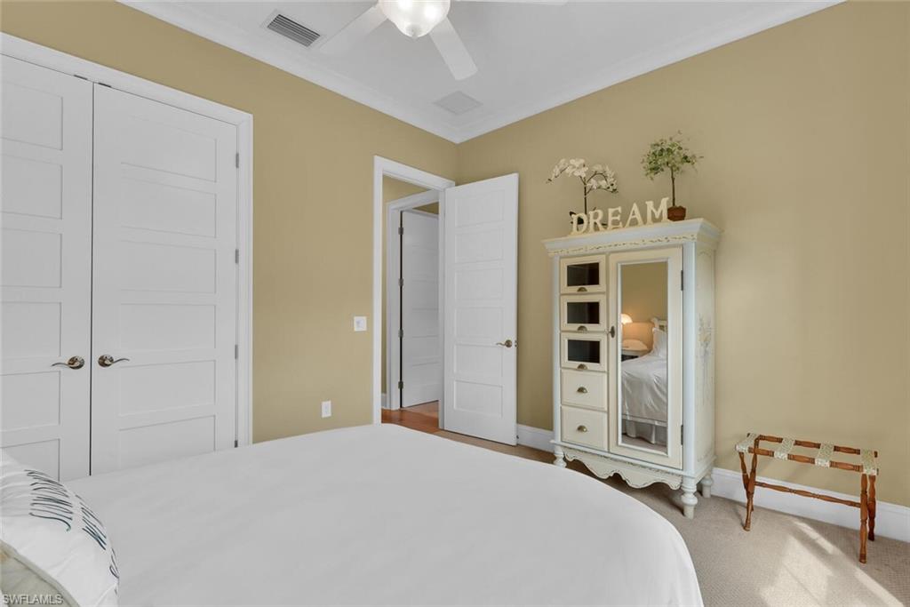 6561 Dominica Drive, Unit 8101 Naples, FL 34113 - Photo 30 of 46 a bedroom with a bed and a window