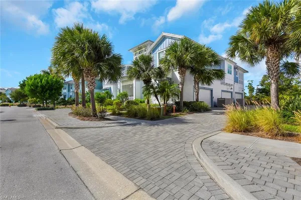 a view of a house with a yard and tree s
