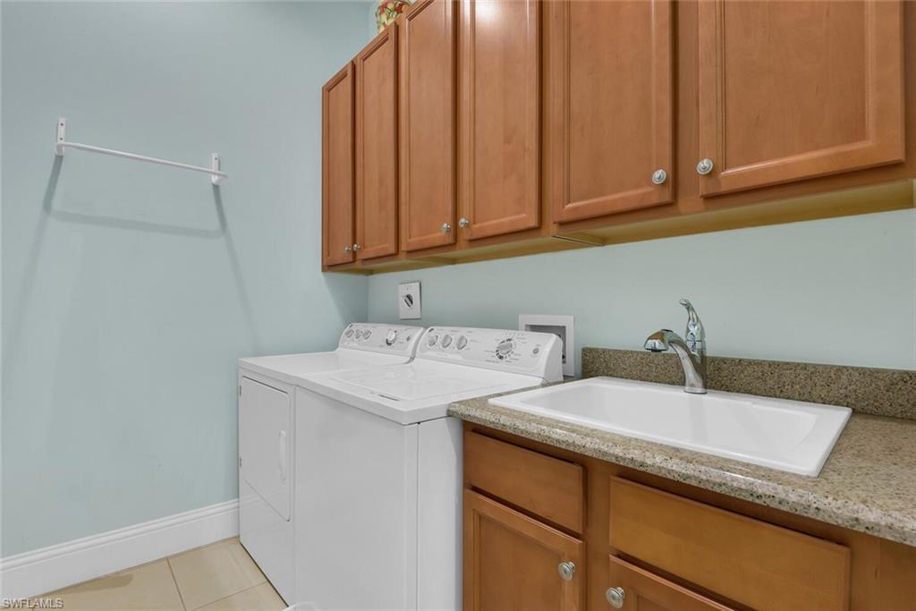 6561 Dominica Drive, Unit 8101 Naples, FL 34113 - Photo 31 of 46 a utility room with dryer and washer