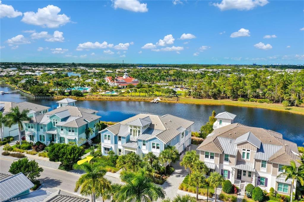 6561 Dominica Drive, Unit 8101 Naples, FL 34113 - Photo 32 of 46 a view of a city with lawn chairs under an umbrella
