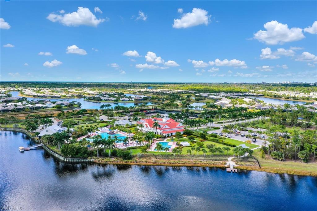 6561 Dominica Drive, Unit 8101 Naples, FL 34113 - Photo 42 of 46 a view of a room with wooden floor fire pit and outdoor seating