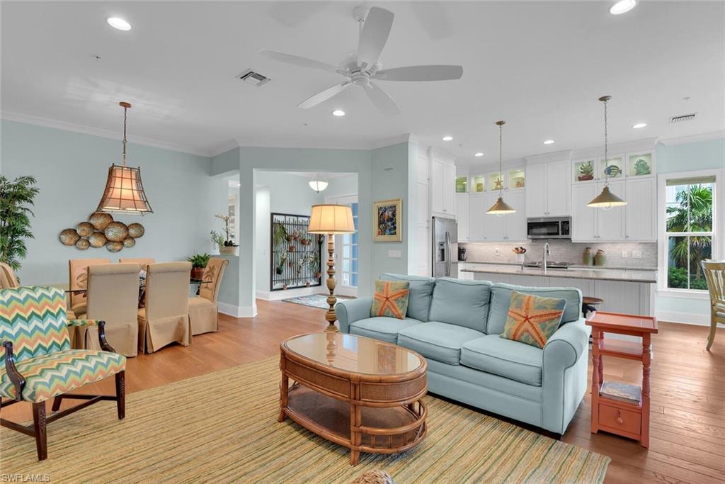 6561 Dominica Drive, Unit 8101 Naples, FL 34113 - Photo 6 of 46 a living room with furniture and a wooden floor