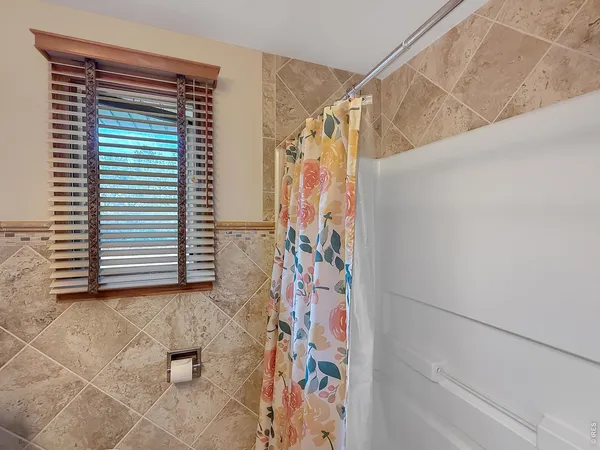 a view of walk in closet with clothes