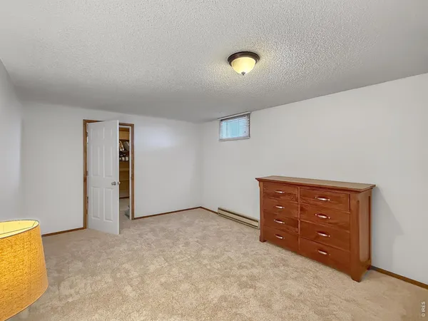 an empty room with a dresser