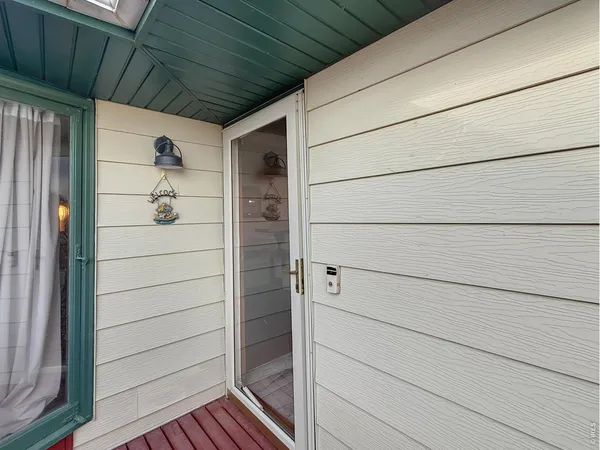 a balcony with wooden floor and furniture