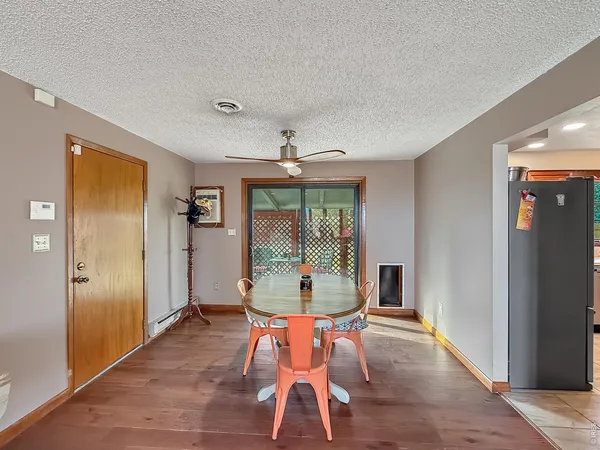 a dining room with furniture window and wooden floor